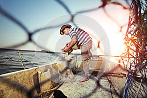 Fisherman at work, cleaning the nets