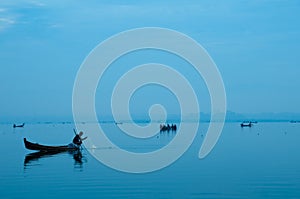 Fisherman working with peaceful twilight sunset at Amarapura.