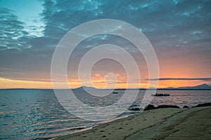 Fishermans rowing in a boat at sunrise