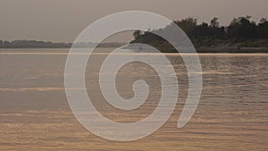 Fishermen on the banks of the Mekong River with sunset.