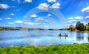 Fishermen in a boat Blagdon Lake Somerset in Chew Valley at the edge of the Mendip Hills south of Bristol like painting in HDR