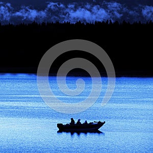 Fishermen in a Boat on a Lake in the Evening or Early Morning