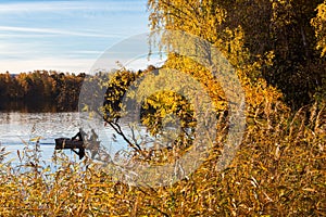 Fishermen in a boat at the reeds in the lake