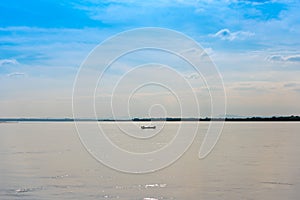 Fishermen in a boat on the river Irrawaddy in Mandalay, Myanmar, Burma. Copy space for text.