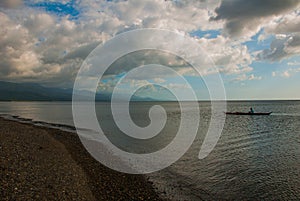 Fishermen in a boat at sea. Landscape sky with clouds. Pandan, Panay, Philippines.