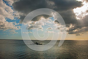 Fishermen in a boat at sea. Landscape sky with clouds. Pandan, Panay, Philippines.