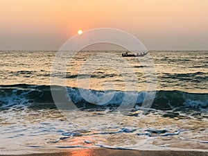 Fishermen in boat at sea with sunset backdrop at paradise beach shiroda