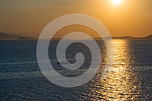 Fishermen boat at sunset in the Mediterranean Sea, near Aegina island, Saronic gulf, Greece