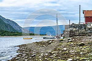 The fishermen boats - modern and very old, small mooring close to fishermen`s old house in Mosjoen town, Norway