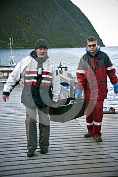 Fishermen carrying fish box