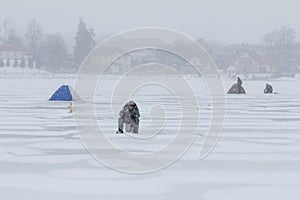 Fishermen catch fish on the ice in winter