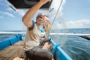 Fishermen catch grouper fish in the sea while fishing