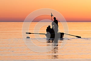 Fishermen checking fishing net in sea on sunrise