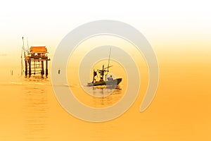 Fishermen collecting shellfish at cockle farming area