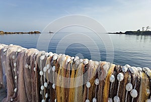 Fishermen colorful nets in front of calm sea water and clear sky. Seaside landscape, wallpaper