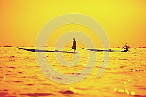 Fishermen at dawn catching fish on Inle Lake