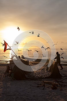 Fishermen emptying their nets on the beach