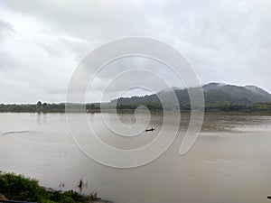 Fishermen find fish in the Mekong River on a rainy day