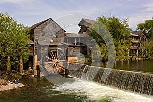 Fishermen fish next to old Mill in Pigeon Forge, Tennessee