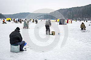 Fishermen fishing on a frozen lake in winter