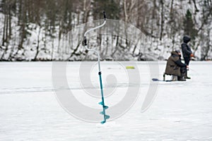 Fishermen fishing on a frozen lake in winter