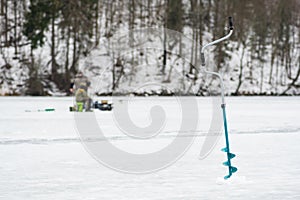 Fishermen fishing on a frozen lake in winter