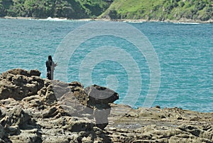 Fishermen fishing on large rocks at Wedi Ombo beach