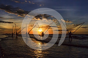Fishermen fishing in the sea at sunrise