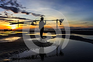 Fishermen fishing in the sea at sunrise