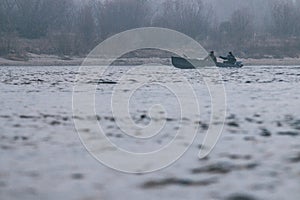 Fishermen float on the river