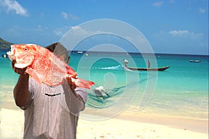 Fishermen, fresh fish & net. Tropical beach.