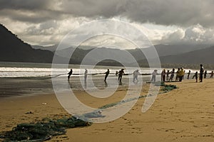 Fishermen hauling nets photo