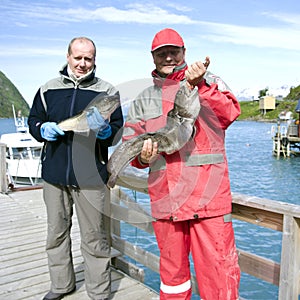 Fishermen holding fish