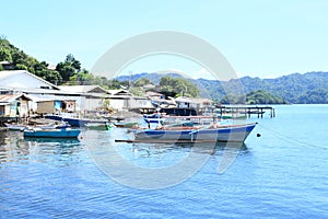 Fishermen houses and anchored boats on the sea