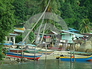 Fishermen houses and fishing boats and pirogues in Pulau Pangkor, Malaysia