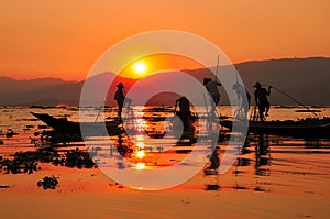 Fishermen in Inle lakes sunset. photo