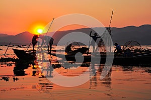 Fishermen in Inle lakes sunset. photo