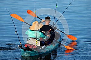 Fishermen kayaking across the river