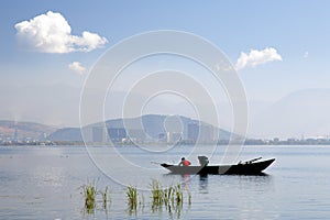 Fishermen on Lake in front of City