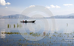 Fishermen on Lake in front of City