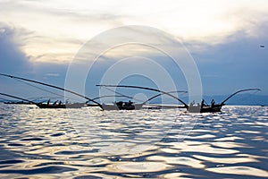 Fishermen on Lake Kivu, Rwanda - Sunset reflection on water