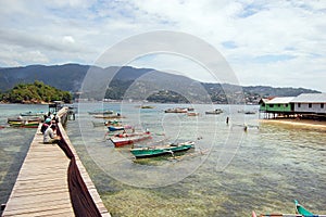 Fishermen at long timber pier