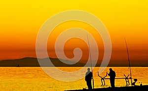 Fishermen beside the Marmara Sea and the boat maintenance pier at sunset