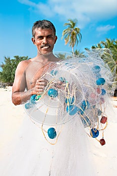 Fishermen with net on tropical beach