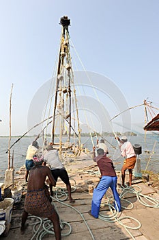 Fishermen operate a Chinese fishing net