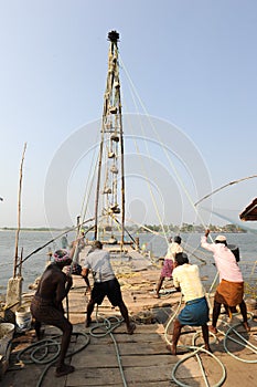 Fishermen operate a Chinese fishing net