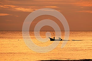 Fishermen out fishing at sunrise in the sea