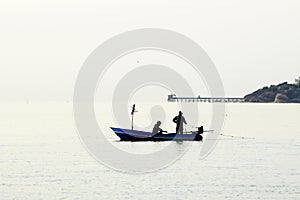 Fishermen out fishing at sunrise in the sea