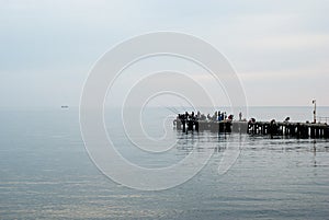 Fishermen on the pier fishing. Black Sea. Crimea.