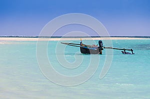 Fishermen pirogue moored on turquoise sea of Nosy Ve island, Indian Ocean, Madagascar